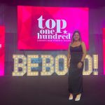 Dr. Melanie Lalonde at the WXN award ceremony standing in front of the BEBOLD sign.