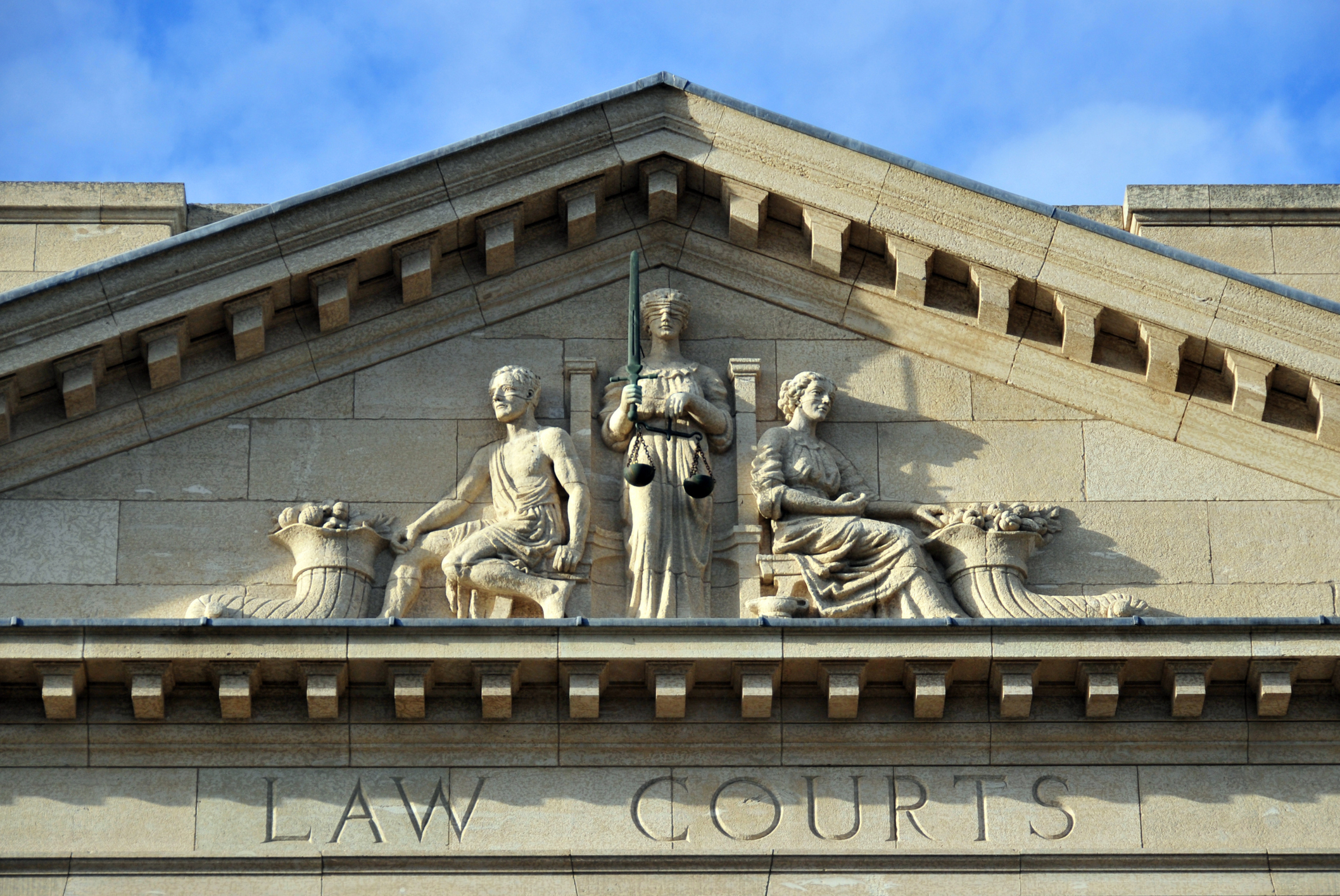 Winnipeg, Manitoba, Canada: historic Provincial Law Courts - pediment : blind justice and cornucopias in the tympanum - photo by M.Torres