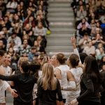 Bisons women's volleyball team waves to the crowd after a game