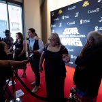 People being interviewed by media at Anishinaabemowin-dubbed Star Wars premiere.