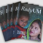 Several copies of the new issue of RadyUM magazine are fanned out on a table.