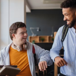 Teacher and student smiling and walking