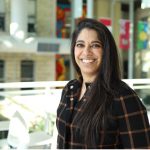 Dr. Farhana Shariff stands in the Brodie Centre atrium on the UM Bannatyne campus.