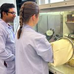 Researchers work in an aerobic chamber