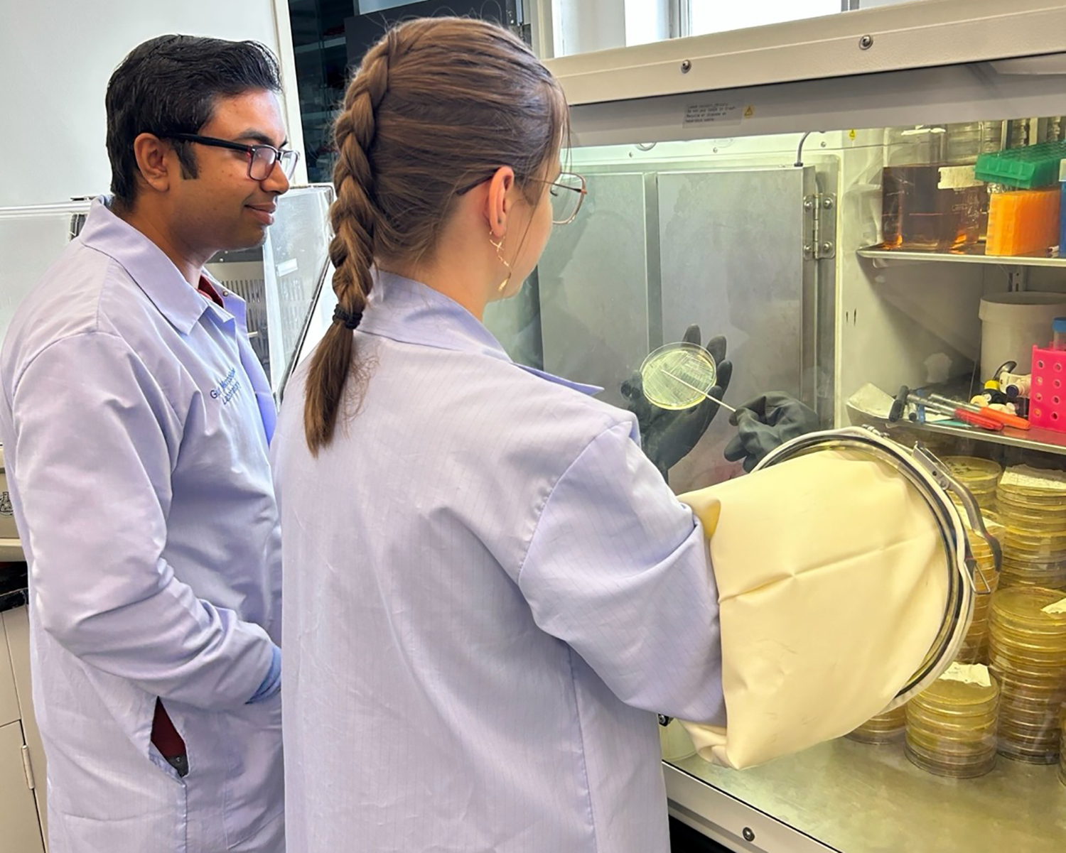 Researchers work in an aerobic chamber