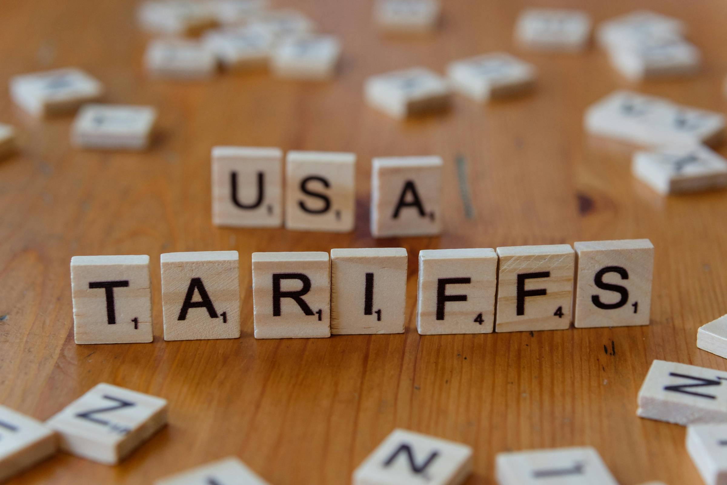 Scrabble tiles spelling out tariffs and USA. Photo credit: Markus Winkler