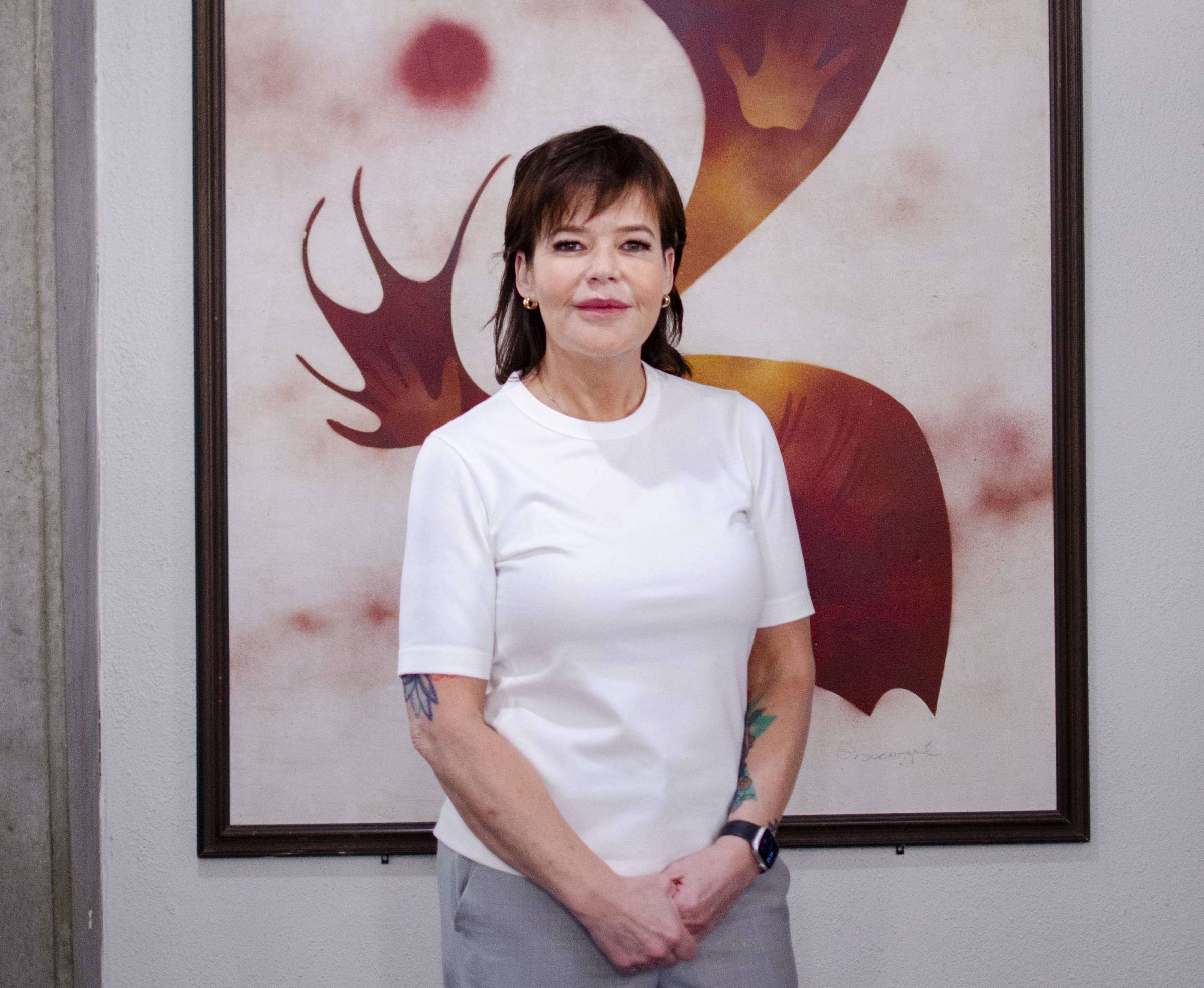 Angela Soulsby standing in font of an abstract painting