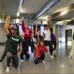 KPER 4000 students pose with their hands up at the end of a routine