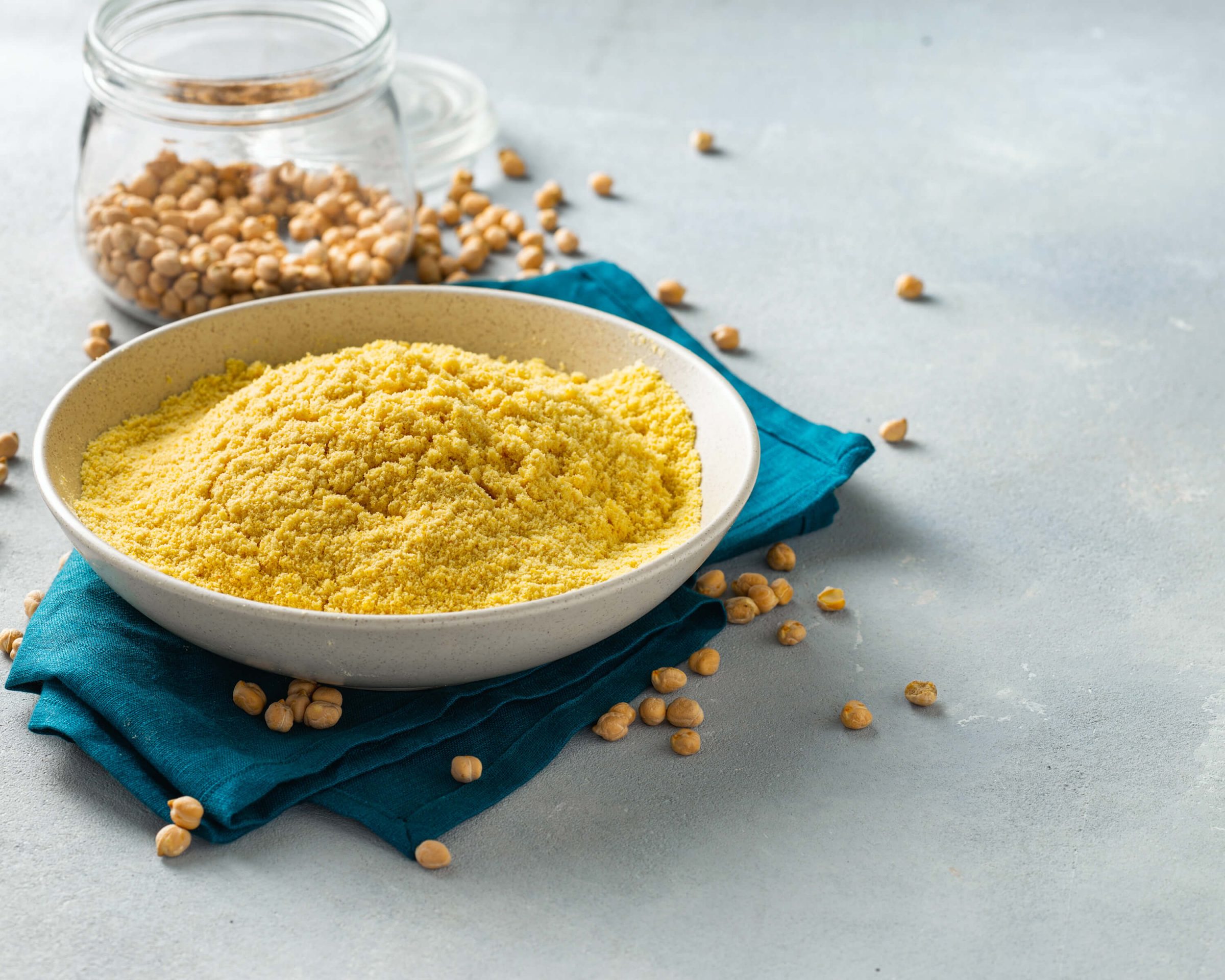 A bowl and container of cooking ingredients sit on a counter