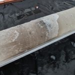 The ice core, showing bits of sand and pebble.