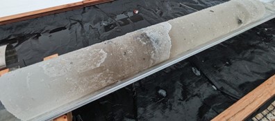 The ice core, showing bits of sand and pebble.