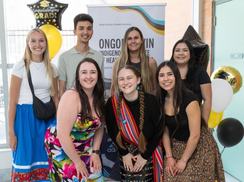 Seven Indigenous graduates of the Rady Faculty pose at their graduation celebration.
