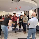 People socializing at an event, playing games and talking to each other.