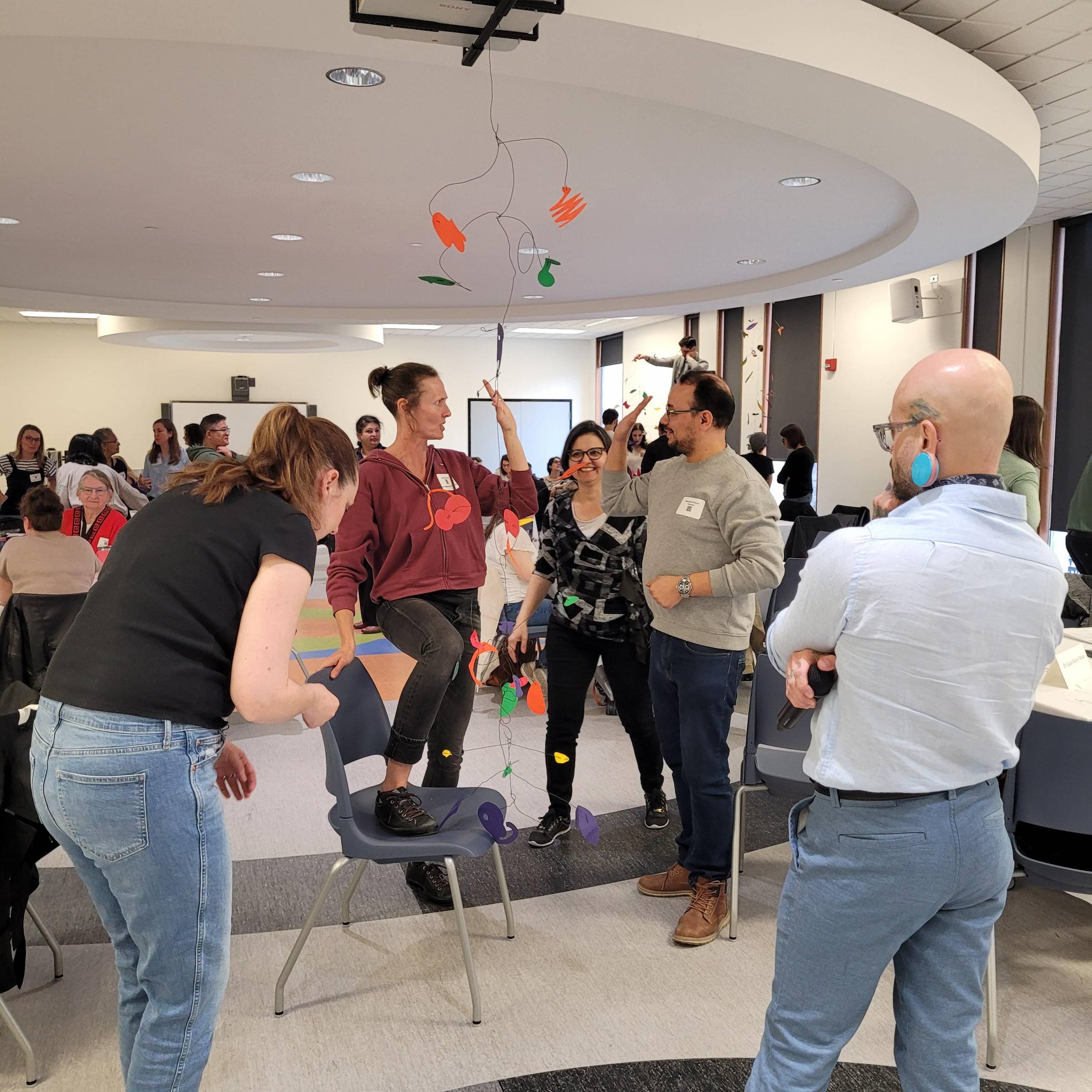 People socializing at an event, playing games and talking to each other.