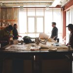 Ryan Gorrie works around a studio table with students
