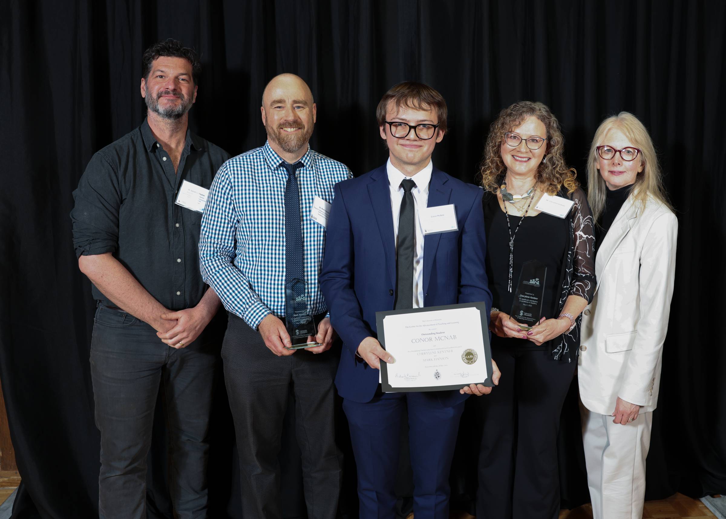 A group of educators pose with Conor McNab and his award.