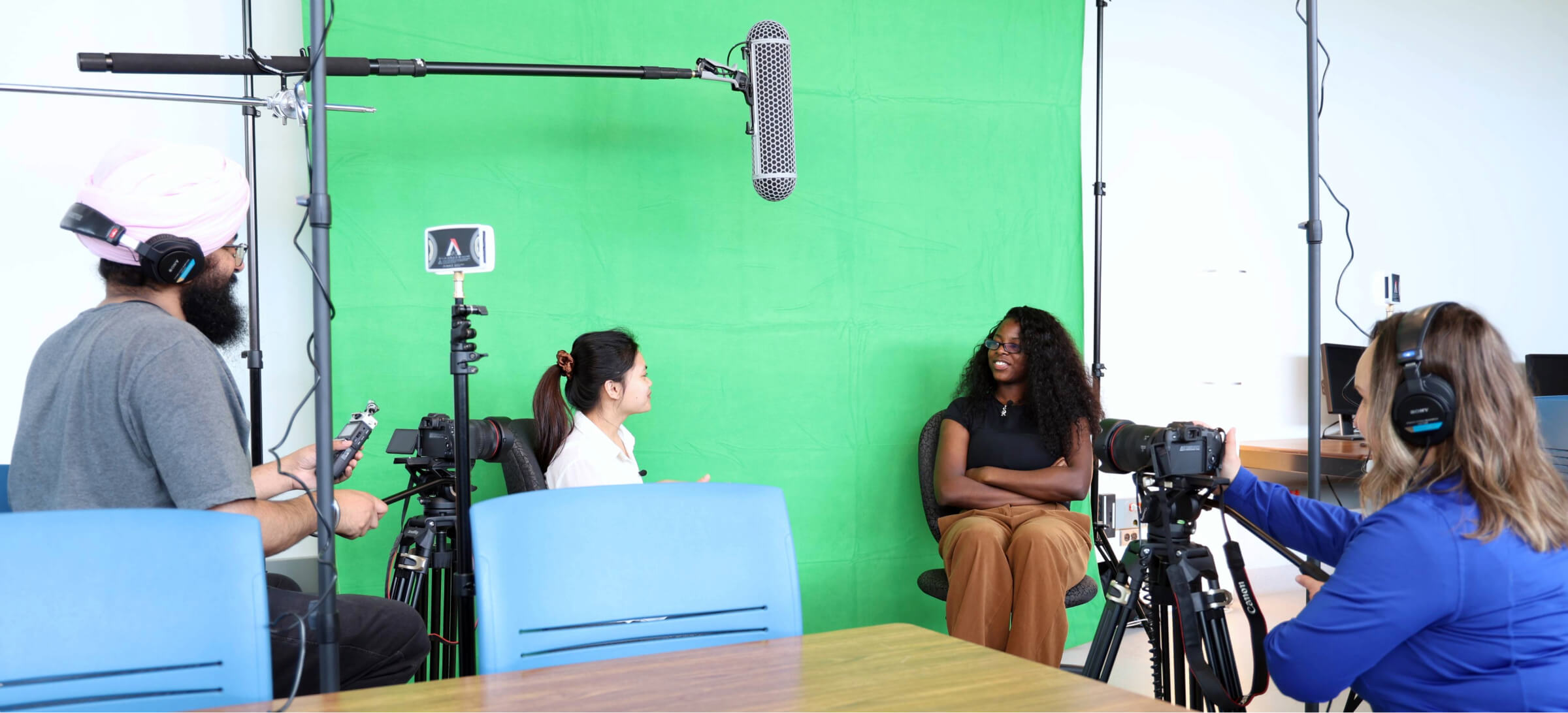 students and staff filming a video in the digital literacies lab