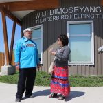 Dr. Reg Urbanowski and Audrey Henderson talk outside of the supportive housing building in Sagkeeng First Nation.