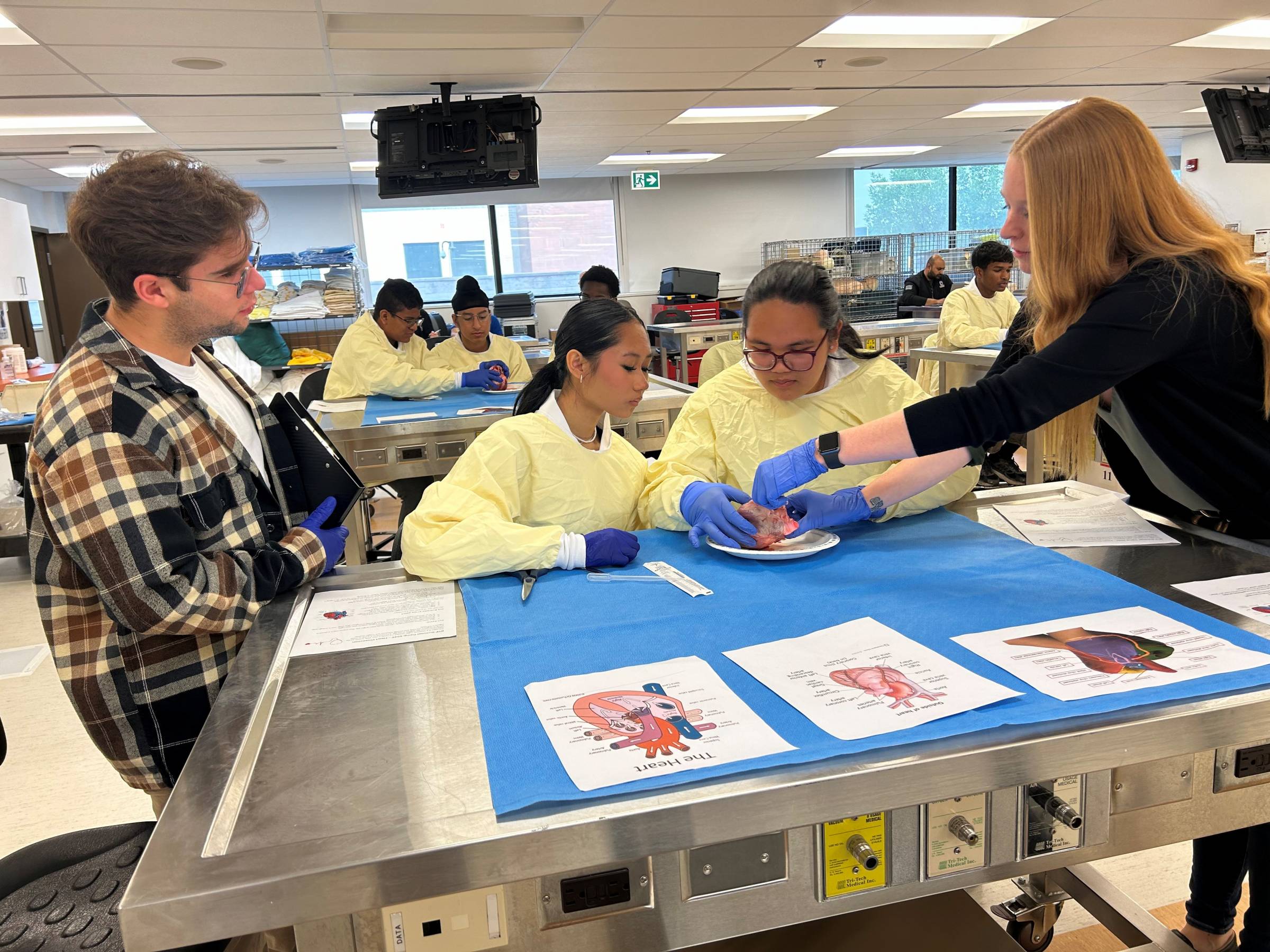 Group of campers in lab coats during a medical workshop.
