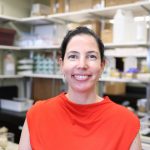 Dr. Zulma Rueda smiling at the camera in her lab.
