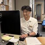 Michael Li works at a computer station in a clinic setting.