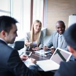 Diverse professionals work together around a table