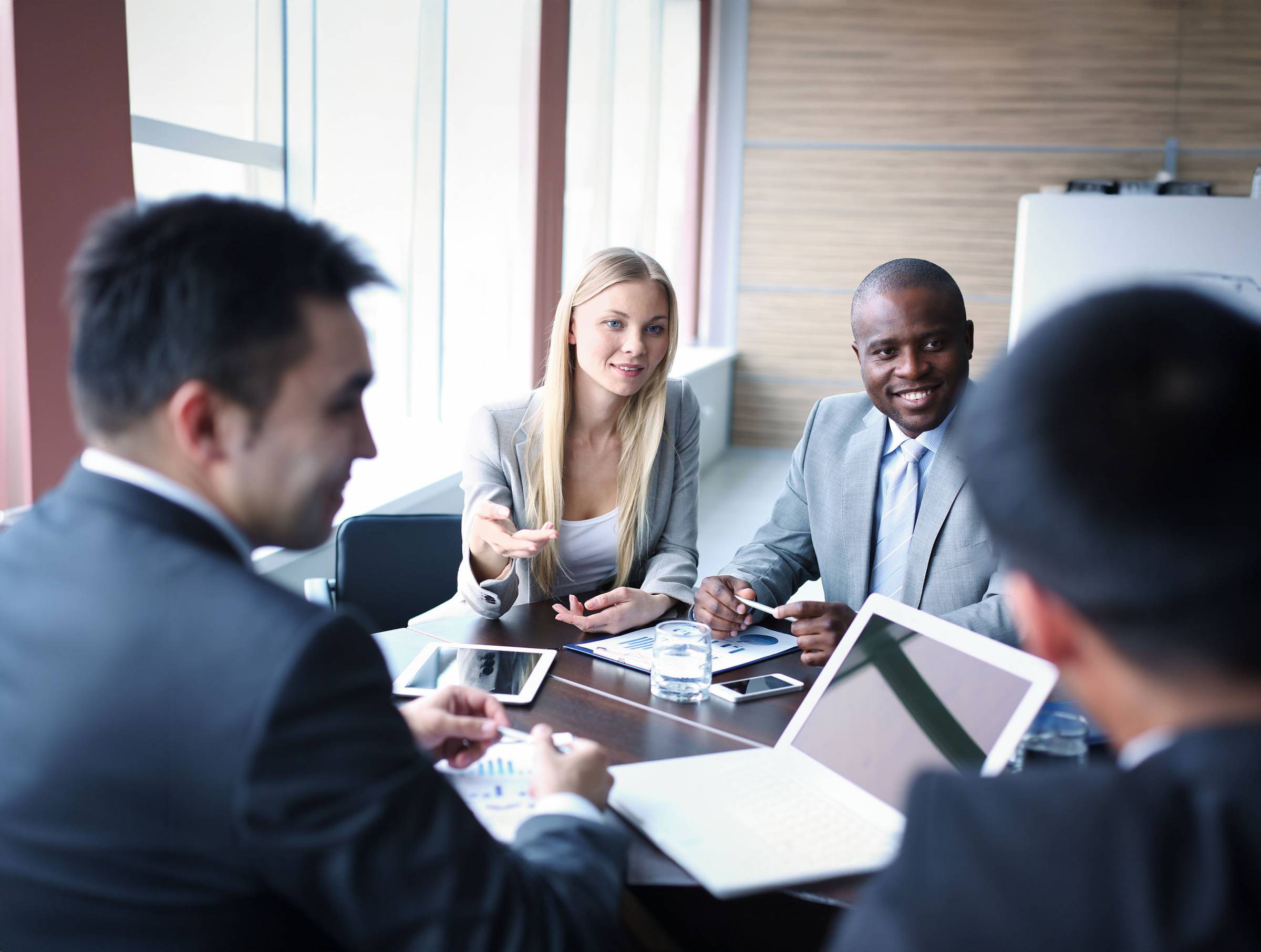 Diverse professionals work together around a table