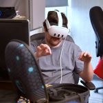 Devon Blewett exploring a virtual world with a VR headset.