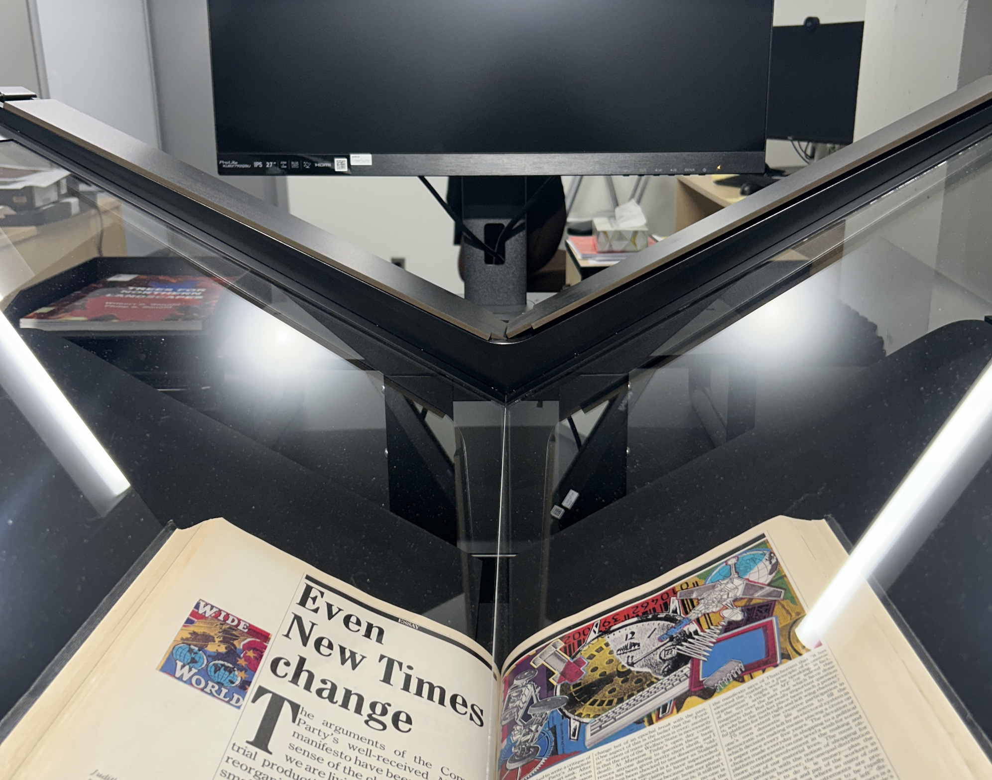 Image of print book in large-format scanner at UM Libraries digitization centre.