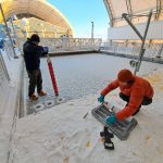 A pair of researchers are conducting tests on ice and water at the Churchill Marine Observatory.