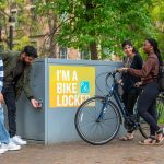 Students gather around a bike locker