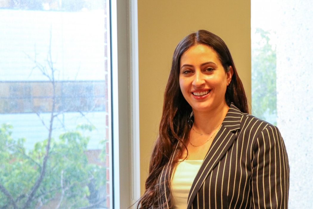 Dr. Amani Hamad standing by a window.