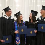 A group of graduating UM students celebrating their success.