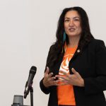 Dr. Angie Bruce speaks at a microphone.