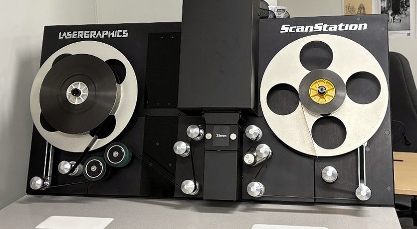 A machine with large wheels used for film digitization
