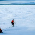 In Canada’s Arctic, David Babb measures the thickness of an ice flow to determine if it’s safe to work on for the day, before deploying the full team