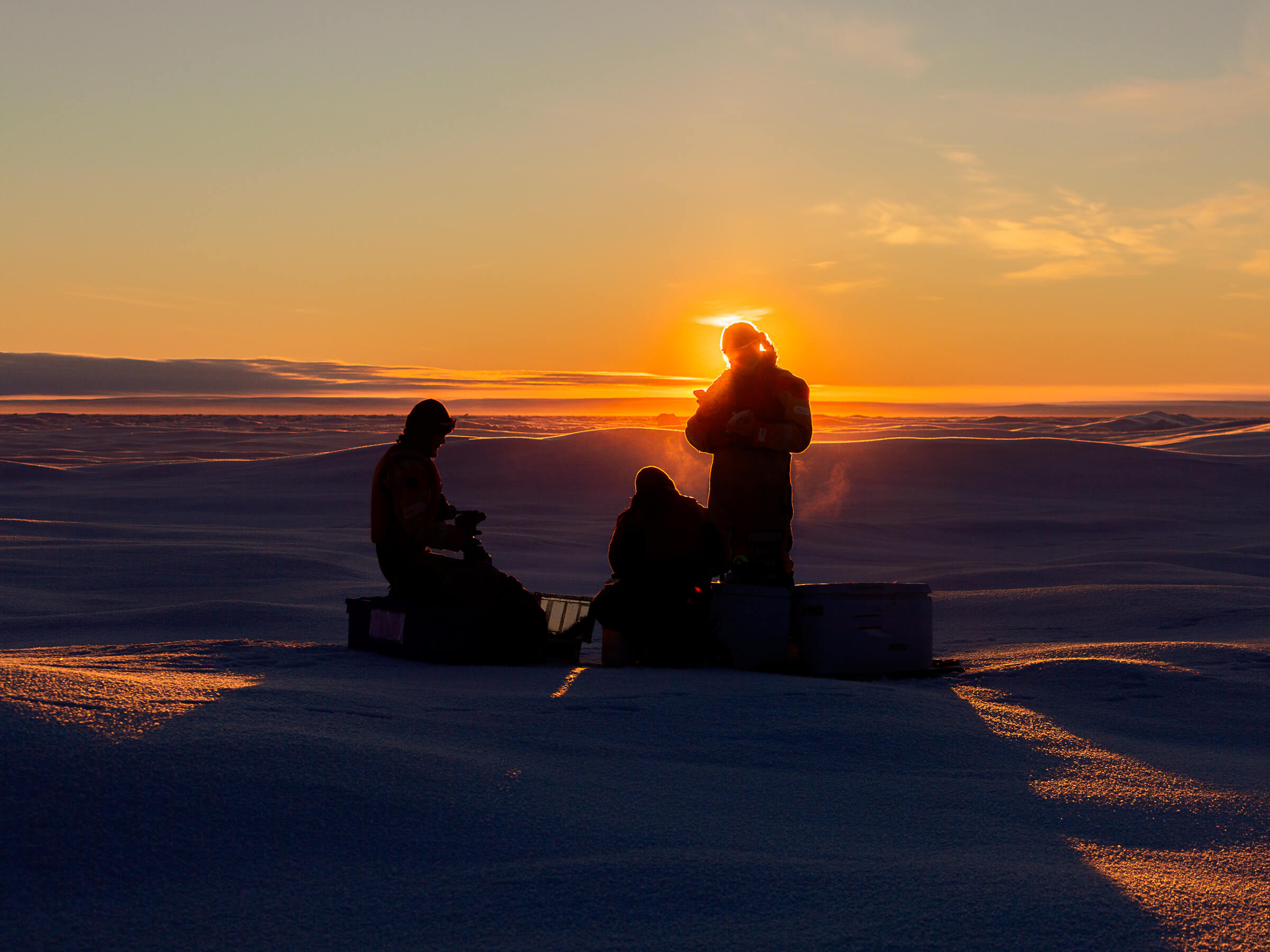Members of the ice sampling team get to work at sunrise // Photo by Clement Soriot