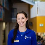 Kaitlin Reilly wearing a University of Manitoba shirt and nametag at Fort Garry campus.