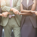 Business professionals join hands in partnership