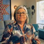Dr. Shannon McDonald smiling at the camera inside her home.