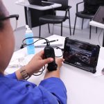 A person using a handheld ultrasound probe on their wrist, imaging is shown on a tablet.