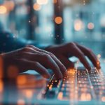 hands typing on a laptop