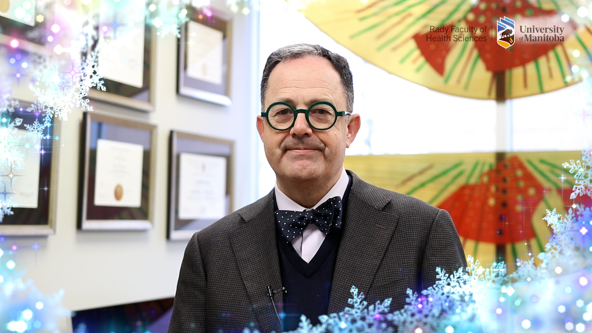 Dean Nickerson speaking in his office frames with sparkling snow